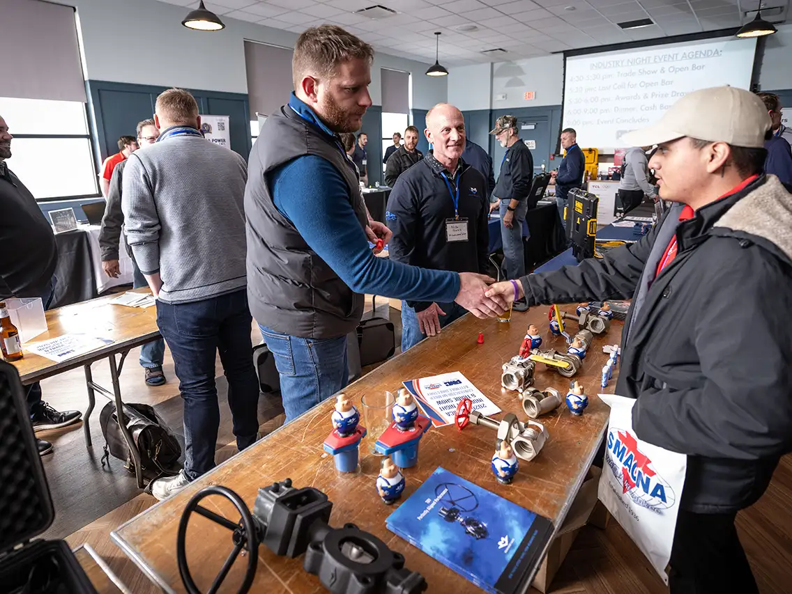 Associate Member and MSOE student shake hands at PMSMCA's Industry Night Trade Show